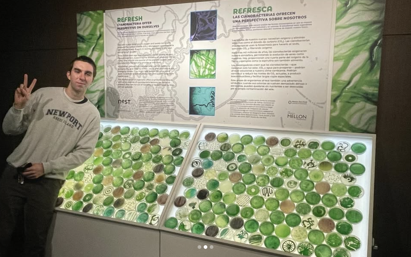 Photo of a Will Allstetter in front of REFRESH: CYANOBACTERIA OFFER PERSPECTIVE ON OURSELVES At the Denver Museum of Nature & Science in the Summit Stage and Expedition Health