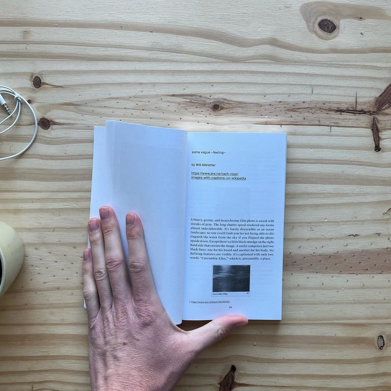 Photo of my hand holding the Are.na Annual Volume 6 physical copy open